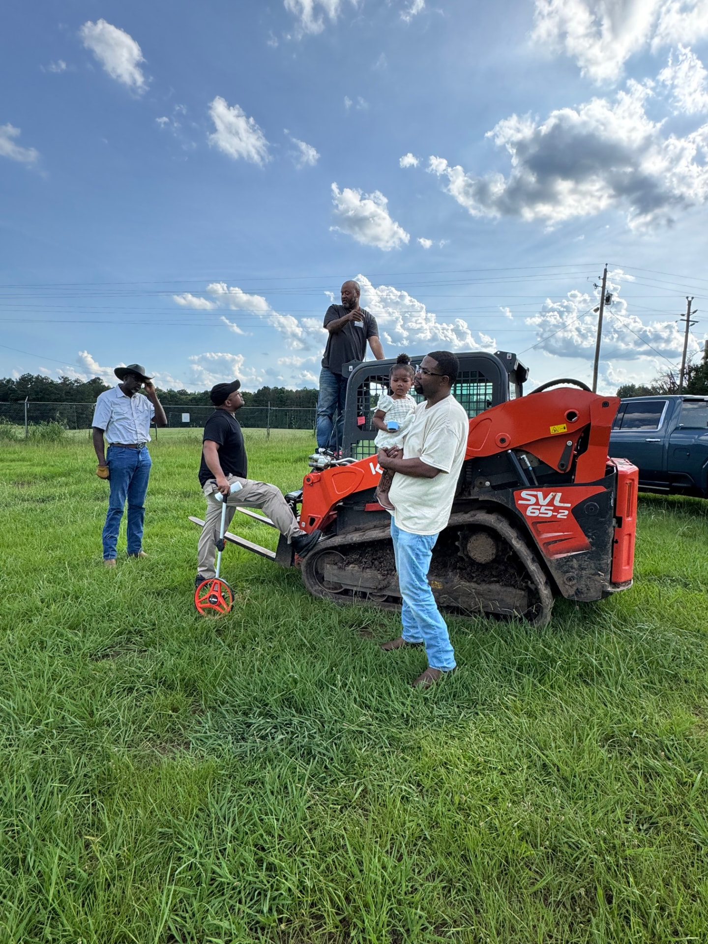 CCEG team planning a community project on-site with construction equipment
